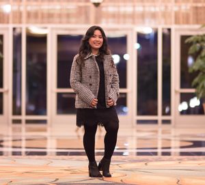 Portrait of smiling young woman standing outdoors