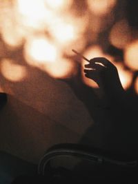 Close-up of hand holding cigarette