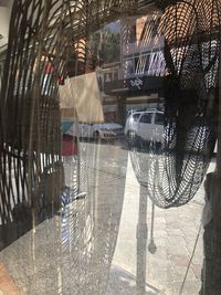 Digital composite image of wet glass window in city