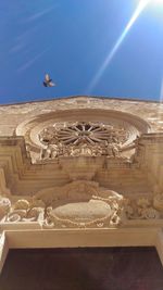 Low angle view of statue against blue sky