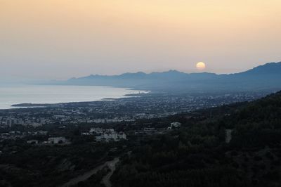 Scenic view of sea and mountains against sky