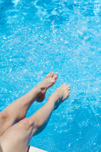 Low section of woman swimming in pool