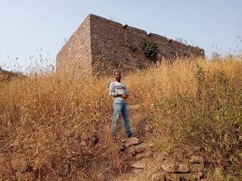 Man standing on field against clear sky