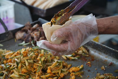 Cropped image of person preparing food at market