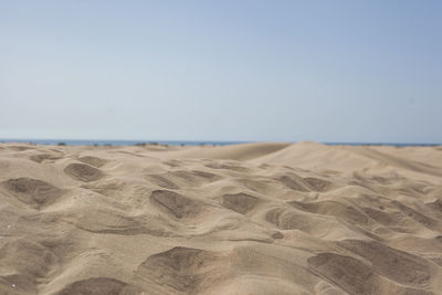 Scenic view of beach against clear sky