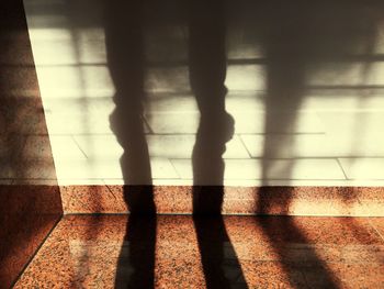 Shadow of people on tiled floor