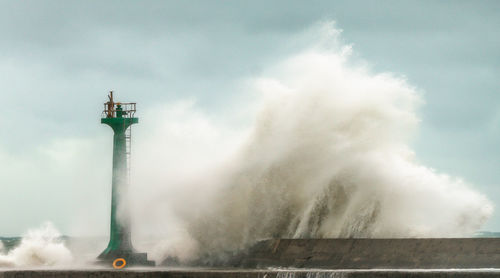 View of lighthouse against cloudy sky
