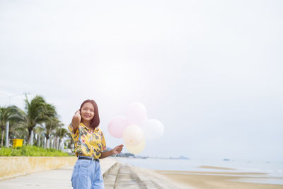 Portrait of smiling young woman standing outdoors