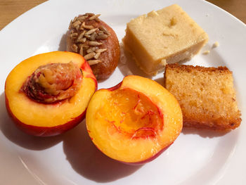 Peach with fruitcake and dessert in plate