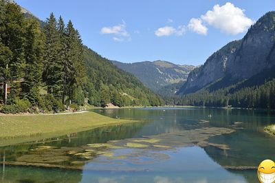 Scenic view of lake and mountains against sky