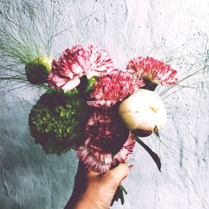 Close-up of hand holding flower bouquet