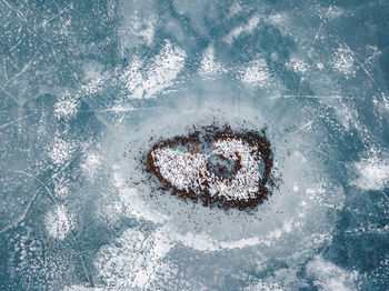 Aerial view of island at frozen lake