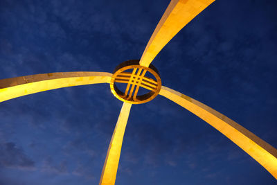 Low angle view of yellow wheel against sky