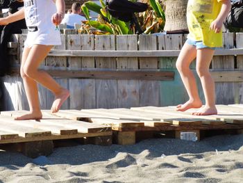 Low section of kids on wooden boardwalk