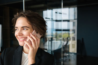 Portrait of young woman using mobile phone