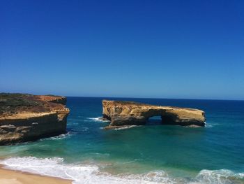 Scenic view of sea against clear blue sky