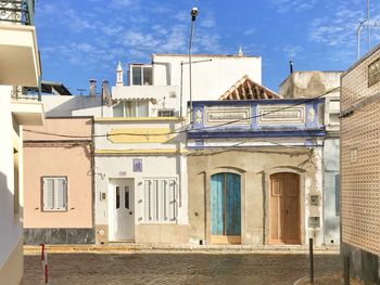 Exterior of buildings in town against sky