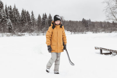 Cute teenage girl rides a snowskate in a winter park, healthy lifestyle