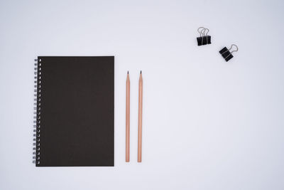 Directly above shot of pencils against white background