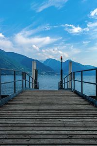 Pier on sea against cloudy sky