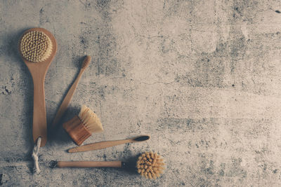 Directly above shot of brushes on concrete table