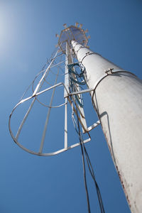 Low angle view of communications tower against sky