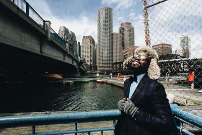 Man standing by river against sky