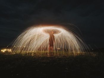 Blurred motion of illuminated light against sky at night