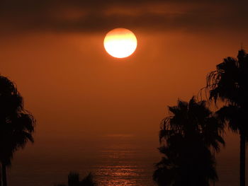 Scenic view of sea against romantic sky at sunset