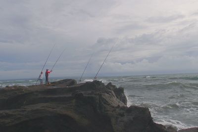 Scenic view of sea against cloudy sky