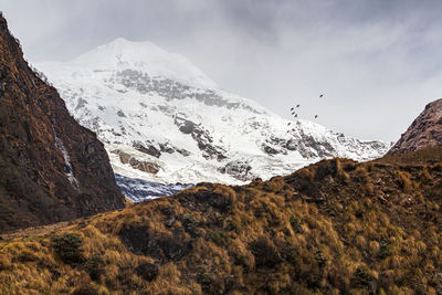 Scenic view of snowcapped mountains against sky