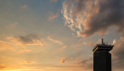 Low angle view of silhouette building against sky during sunset
