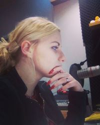 Portrait of a young woman looking away at home
