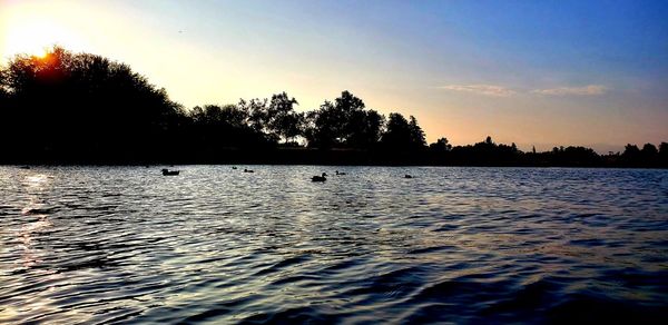 Scenic view of lake against sky during sunset