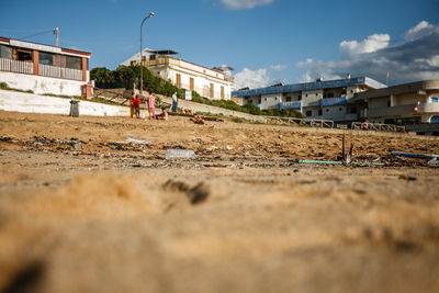 Low angle view of people standing in front of buildings