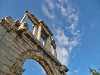 Low angle view of old ruins against sky on sunny day