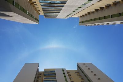 Low angle view of buildings against blue sky