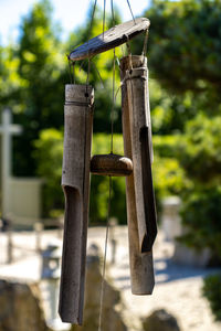 Close-up of wooden post hanging on pole