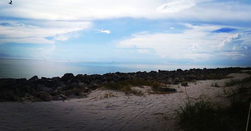 Scenic view of sea against cloudy sky