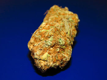 Close-up of bread on table against blue background