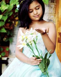 Young woman holding flower bouquet