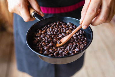 Midsection of woman holding coffee cup