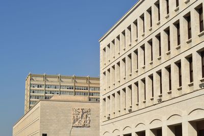 Low angle view of building against clear blue sky
