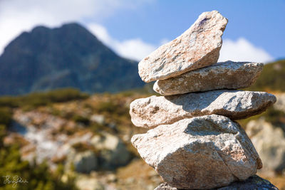 Close-up of stack of rock against sky