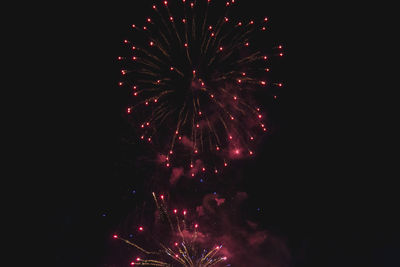 Low angle view of firework display at night