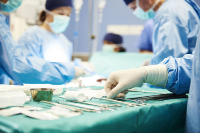 Doctors operating patient in emergency room