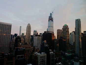 Modern buildings in city against sky in manhattan