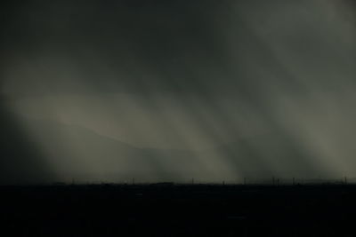 Silhouette landscape against sky at night