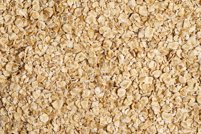 Rolled oat, oat flakes background or texture. close up, directly above.