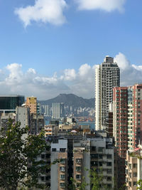 Buildings in city against sky in hong kong